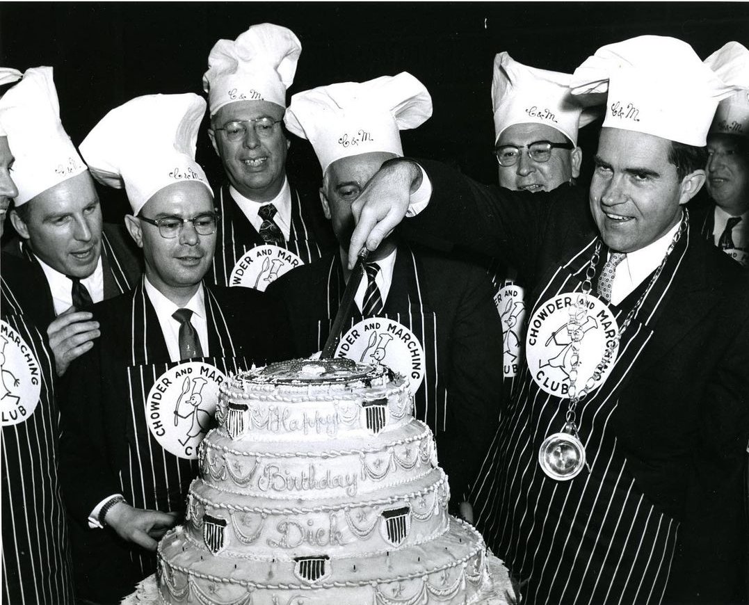 Richard Nixon cutting up a very American themed birthday cake